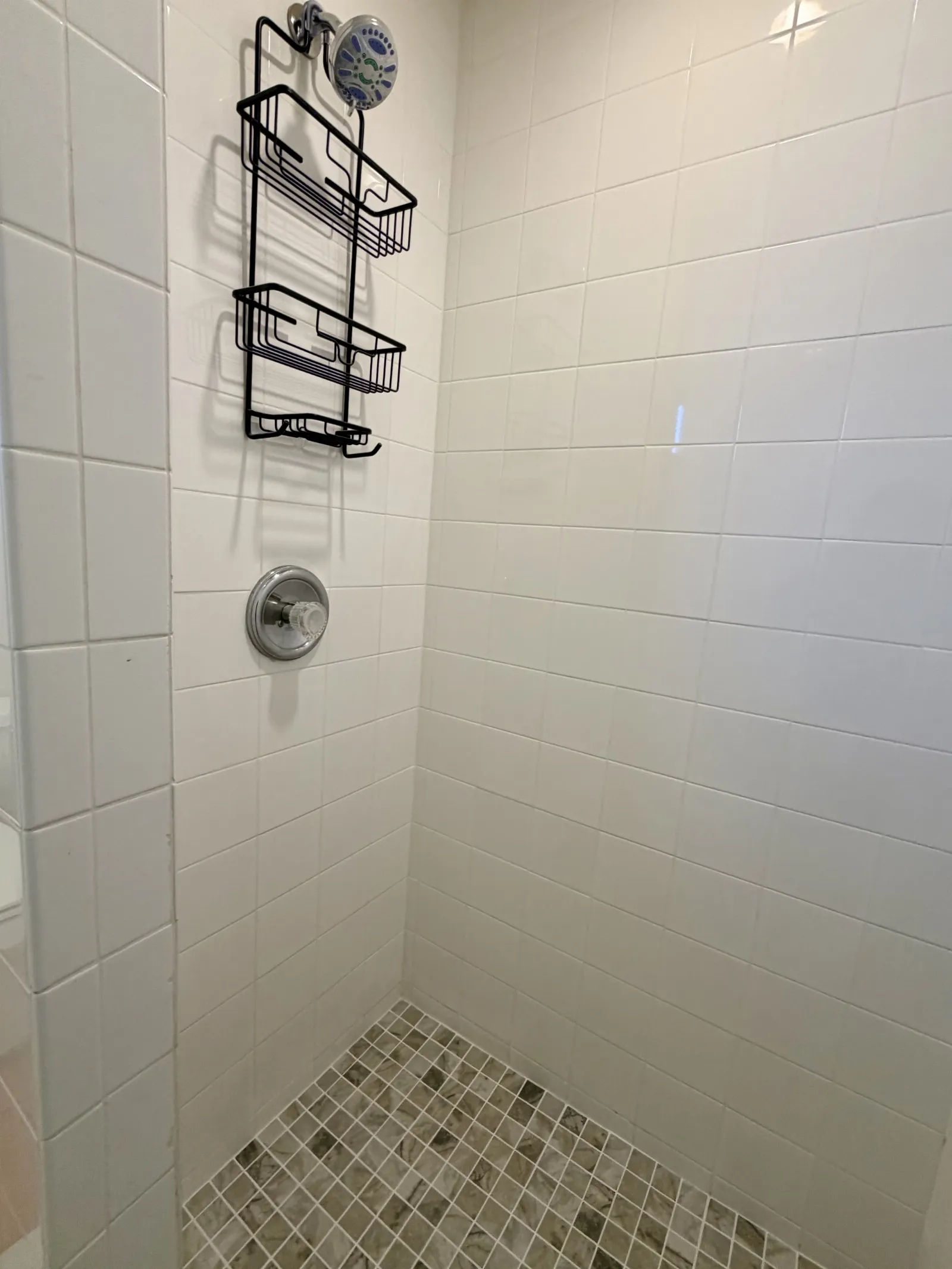 New shower tan and white tile flooring