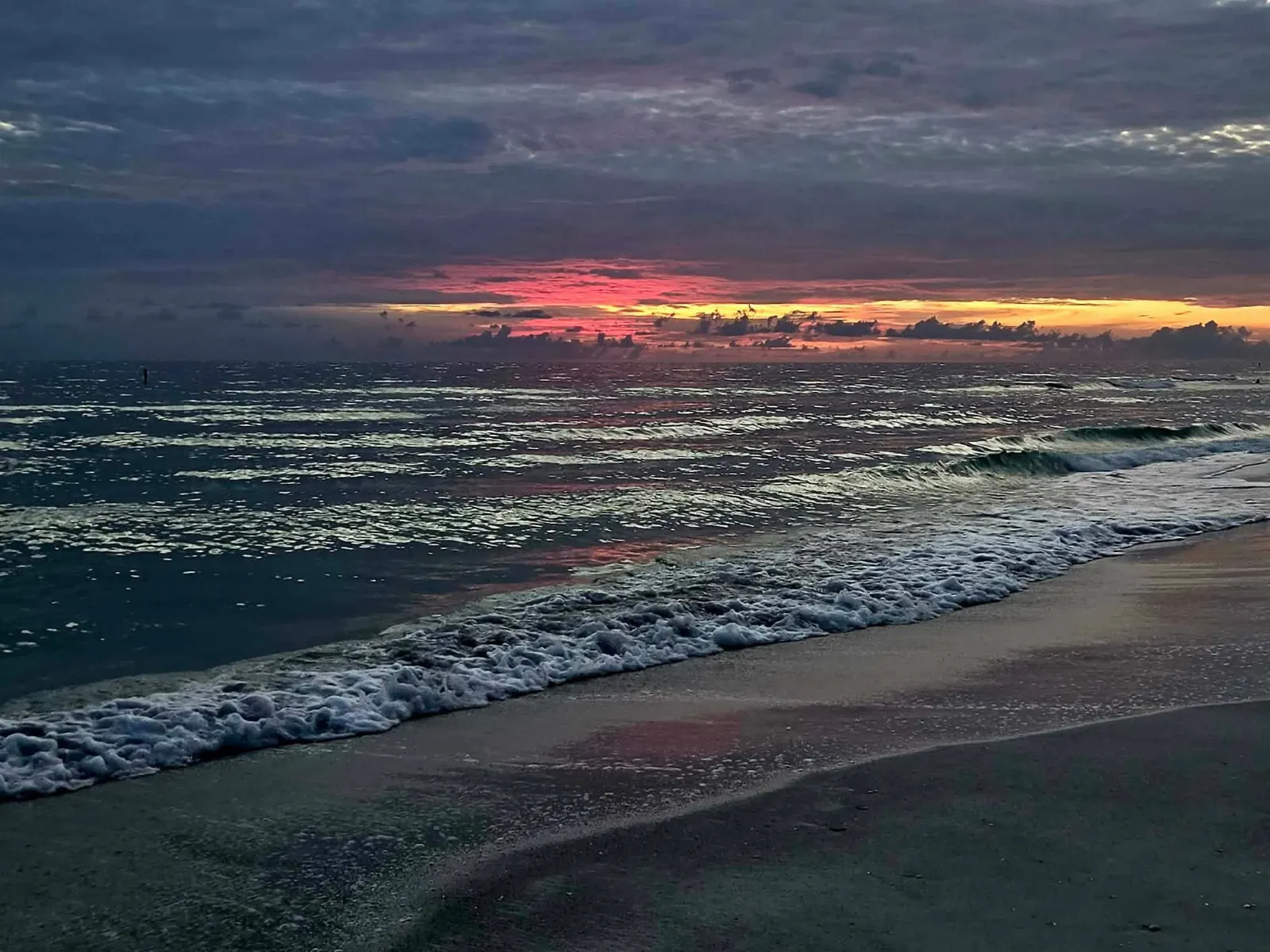 Vibrant orange and pink sunset over the Gulf of Mexico viewed from Bradenton Beach