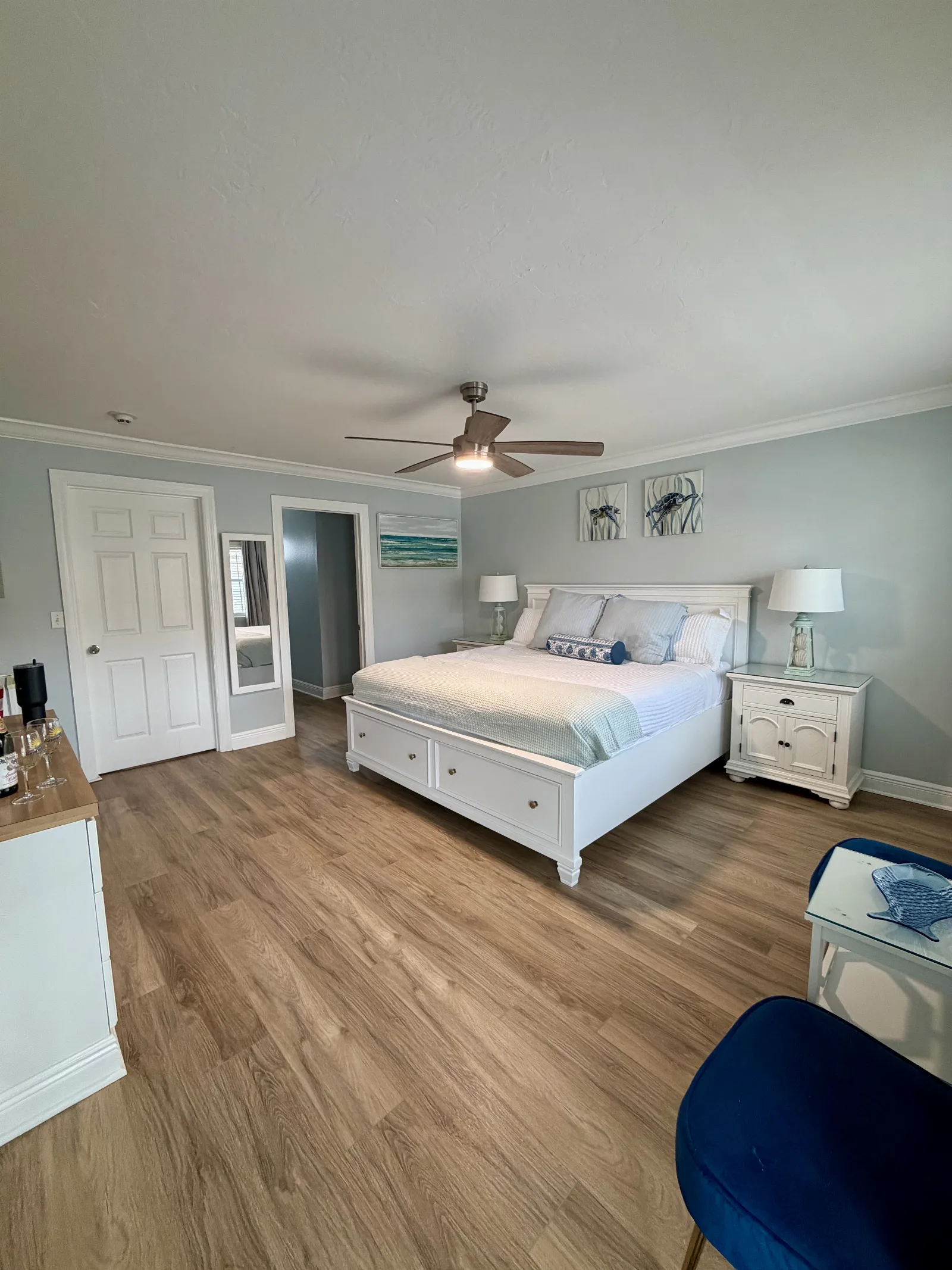 The Unit 248B "The Seaside" room view of king bed, hutch and draws, and bathroom door