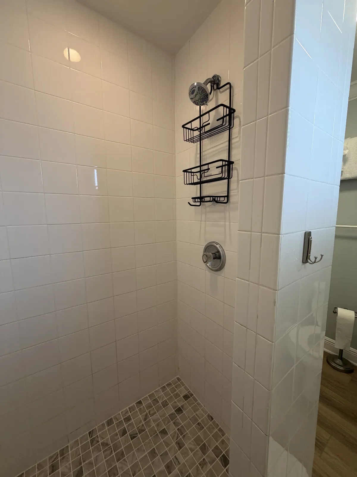 Unit 248A called "The Sands" bathroom shower with new tile floors (black & white)